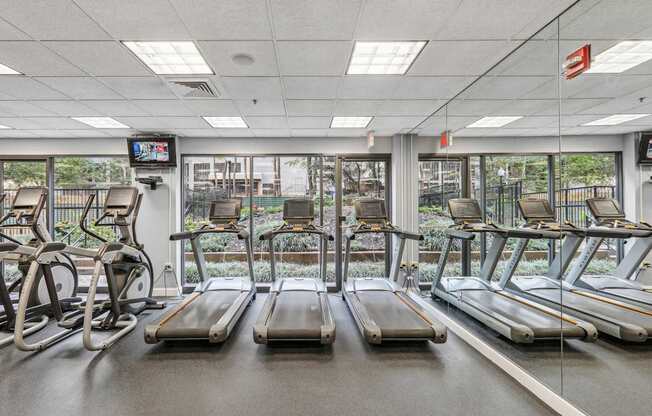 a gym with treadmills and other exercise equipment