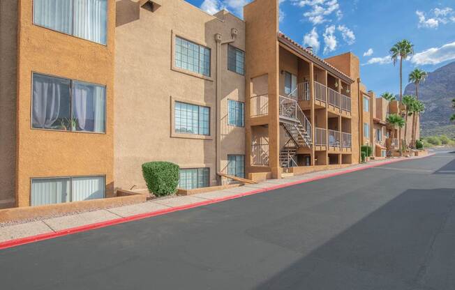A street view of a residential area with apartment buildings.
