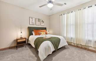 a bedroom with a bed and a ceiling fan