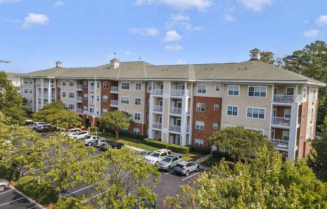 an aerial view of an apartment building with a parking lot