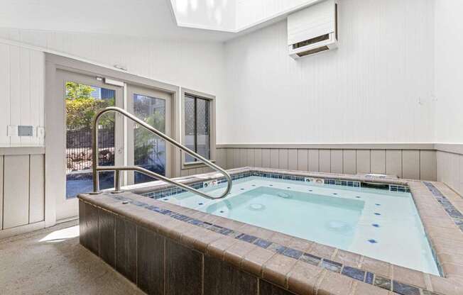 A small indoor pool with a skylight above it.