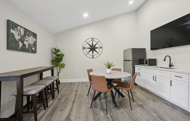 Community Clubhouse with Kitchenette Area and TV at Villages at Metro Center Apartment located in Phoenix, AZ.