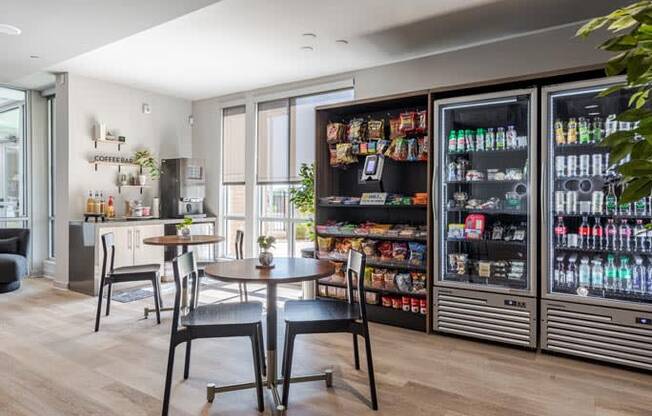 a dining room with a table and chairs in front of a refrigerator