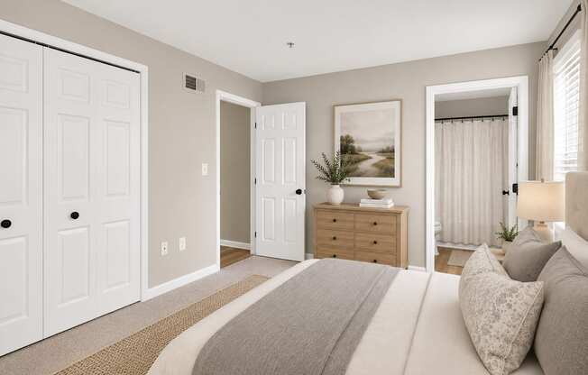 A bedroom with a large bed and a painting on the wall.
