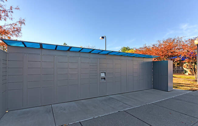 the side of a garage with a blue roof at Cumberland Place Apartment Homes, Tyler 75703