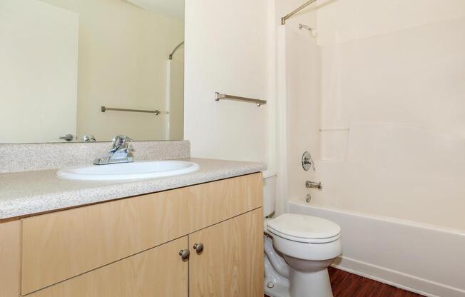 a white tub sitting next to a shower