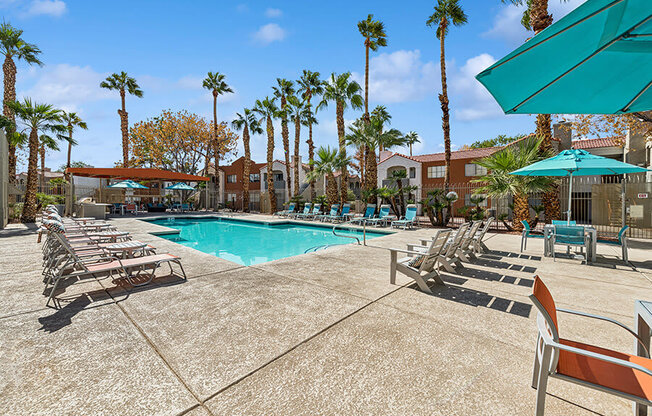 Community Swimming Pool with Pool Furniture at Stonegate Apartments located in Las Vegas, NV.