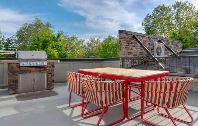 a patio with a table and chairs and a grill at Delano, Redmond Washington