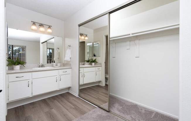 A bathroom with a large mirror and a sink.