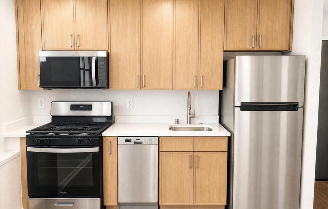Newly redesigned kitchen featuring modern cabinetry, stainless steel appliances, and sleek countertops.