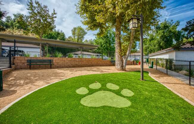 a yard with a paw print on the grass at Canyon Crest, Riverside, CA