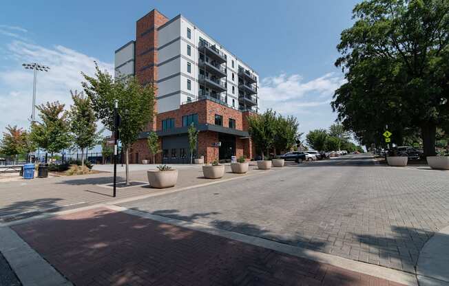 a city street with a building and trees on the side of it