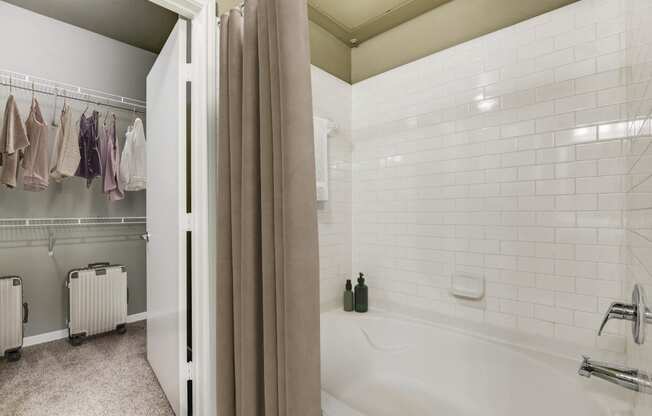 a bathroom with a tub and shower and a shower curtain