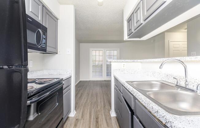 a kitchen with a sink and a window