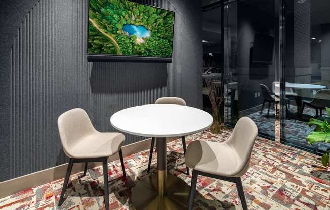 A modern dining area with a round table and chairs.