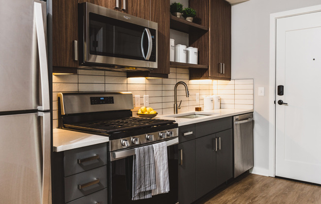 Kitchens with stainless steel appliances and custom cabinetry with chrome pulls