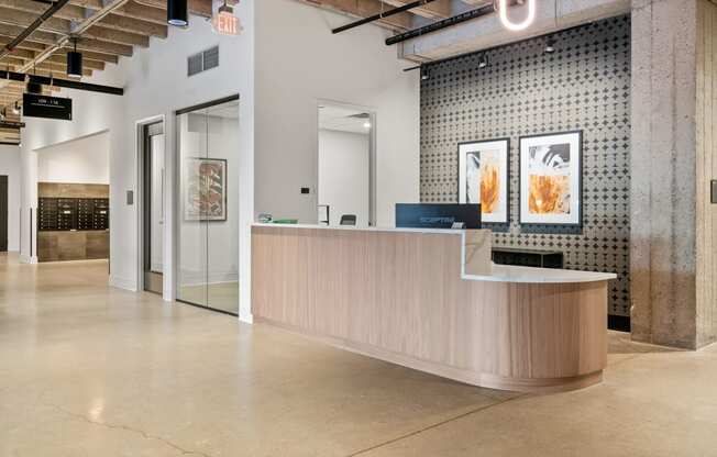 a lobby with a reception desk and a glass door