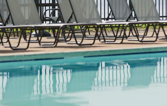 a group of lounge chairs next to a swimming pool at Tindeco Wharf, Baltimore, MD