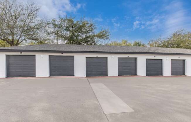 a row of garage doors in front of a building