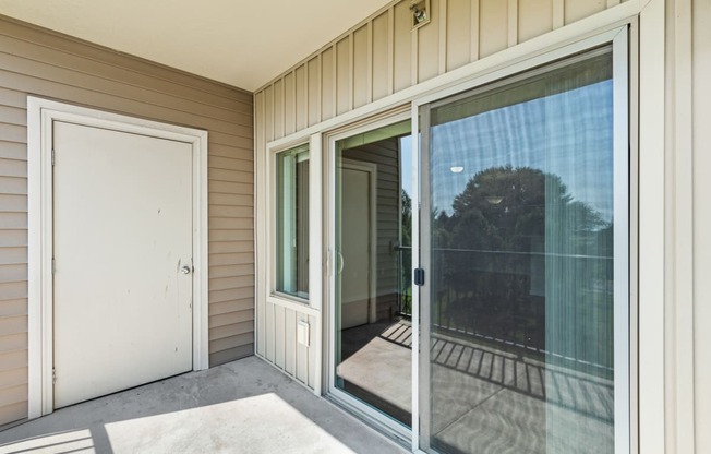 a large sliding glass door leading to a balcony