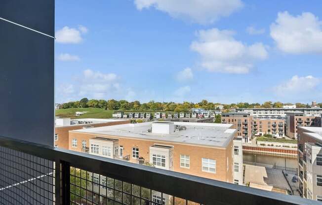 the view of the city from the balcony of an apartment building