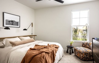 a bedroom with a bed and a window