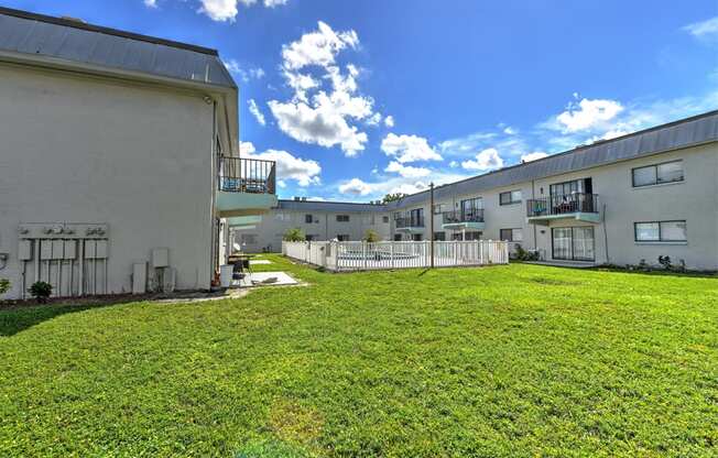 A grassy area in front of apartment buildings.