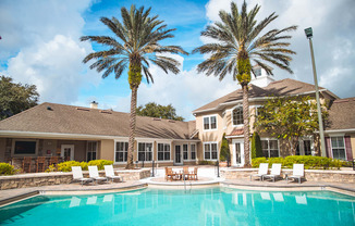 A large house with a pool in front of it.