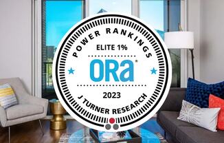a living room with a couch and a table with the ora logo on it