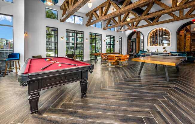 a games room with a pool table and tables at The Alibi at Lake Lilly, Ocoee, FL, 34761