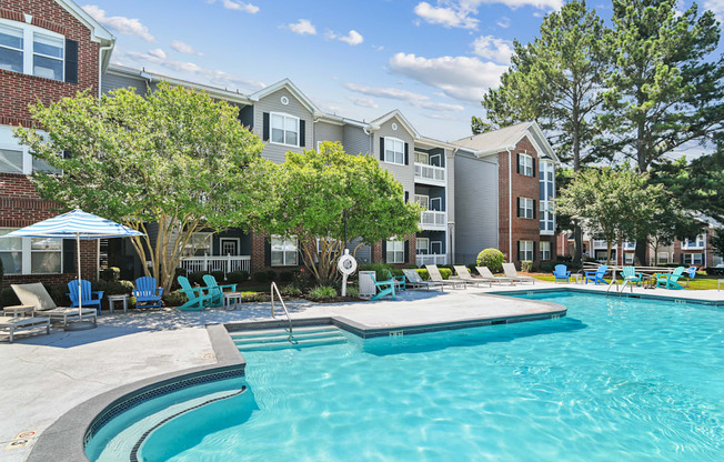 A swimming pool in front of a residential building.