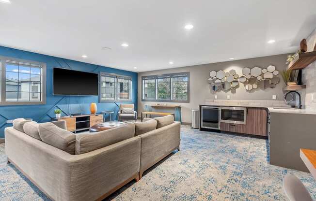 A living room with a large couch and a television.