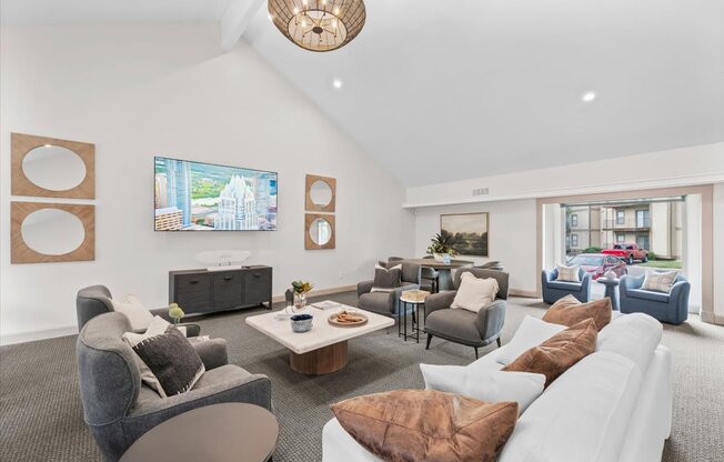 A living room with a grey couch and a white couch.
