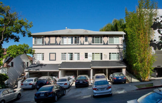 Exterior front view of an apartment building with parking spaces