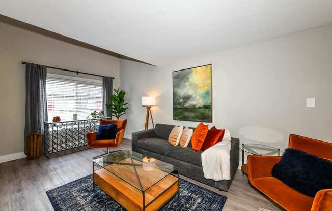 a living room with a couch coffee table and a window