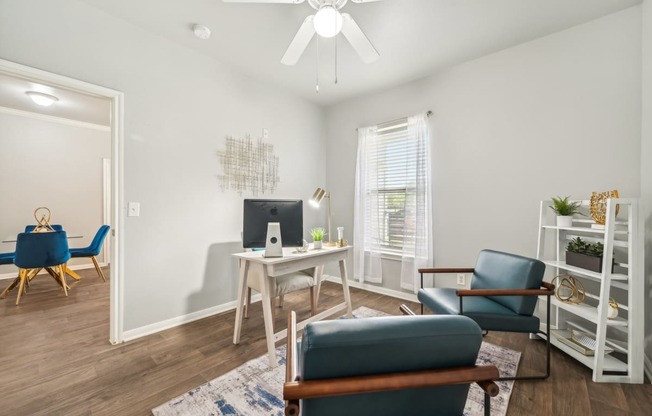 a living room with white walls and a table and chairs