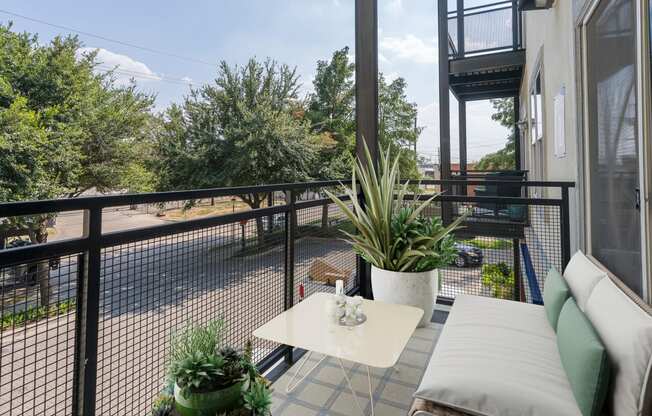 a living room with a couch and a table on a balcony