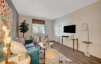 A living room with a green couch and a wooden coffee table.