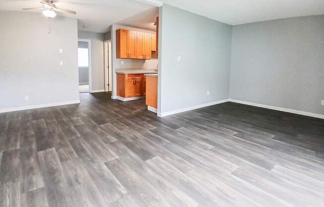 A room with wooden flooring and a ceiling fan.