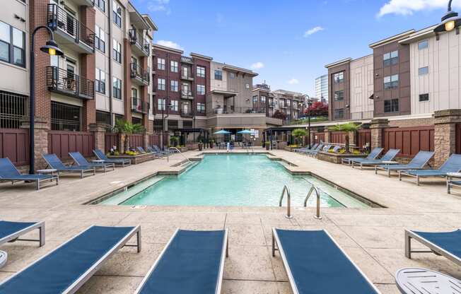 our apartments have a large pool and lounge chairs in front of our building