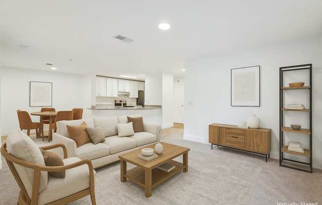 A living room with a white couch, a wooden chair, and a wooden coffee table.