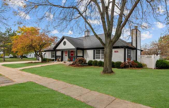 A house with a tree in front of it.