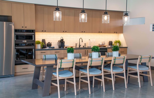 a large kitchen with a long wooden table and chairs