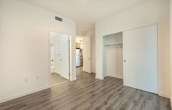 a renovated living room with white walls and wood floors