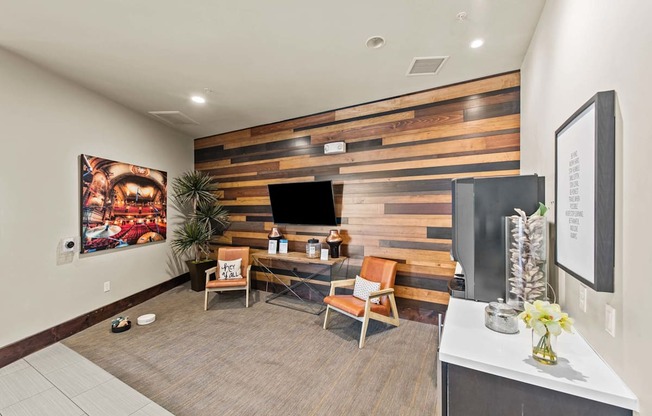 a home office with a wooden wall and a television