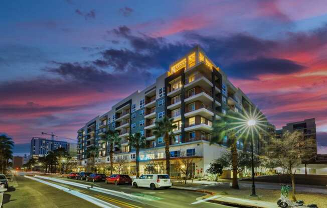 a large building with a pink and purple sky in the background at The Rey Downtown, Arizona