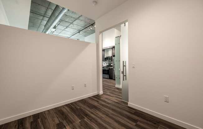 Bedroom with high ceiling open to work space in a Live and Work apartment at 1400 FIG Apartments in Los Angeles, California.