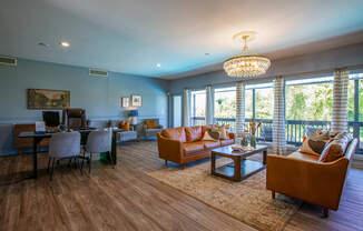 A living room with a large window and a balcony.