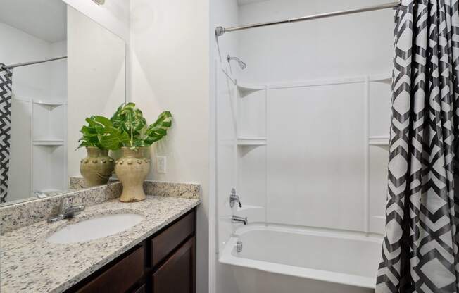 Bathroom with a shower and a sink and a mirror  at The Meadows, Bloomingdale, GA