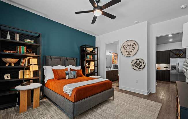 a bedroom with a bed and a ceiling fan